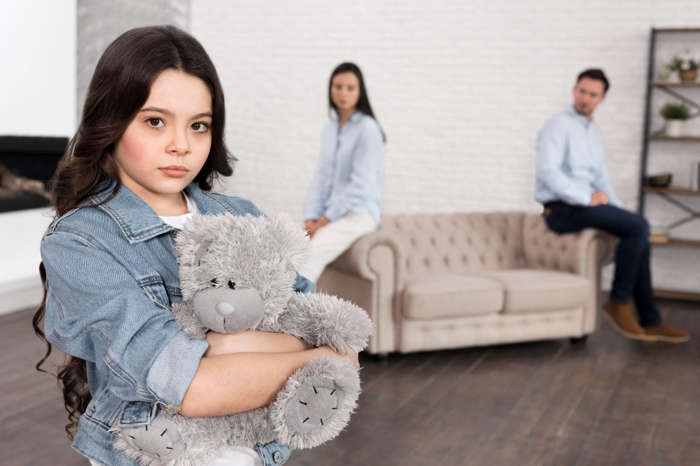 Portrait of sad girl holding teddy bear

