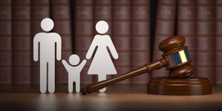 figure family standing behind gavel with bookshelf backdrop