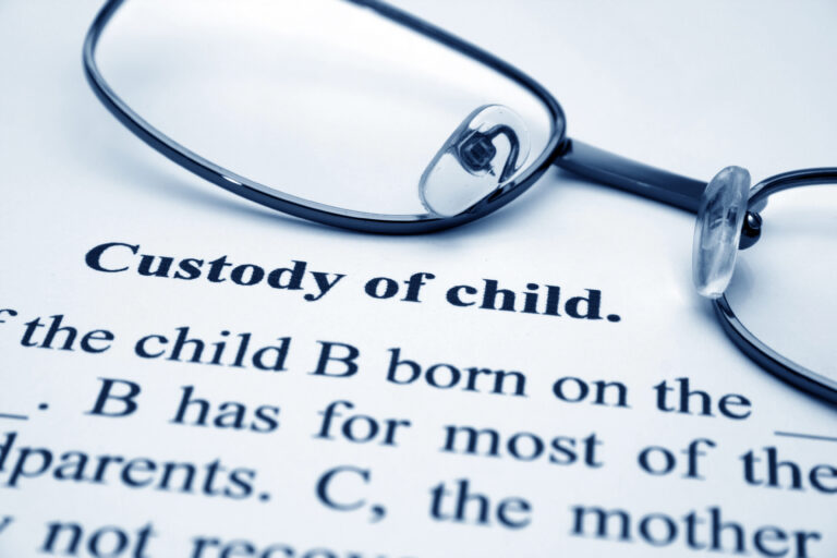 picture of pair of glasses on child custody papers