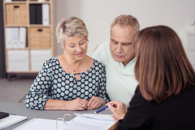 elderly couple talking to lawyer about estate plan