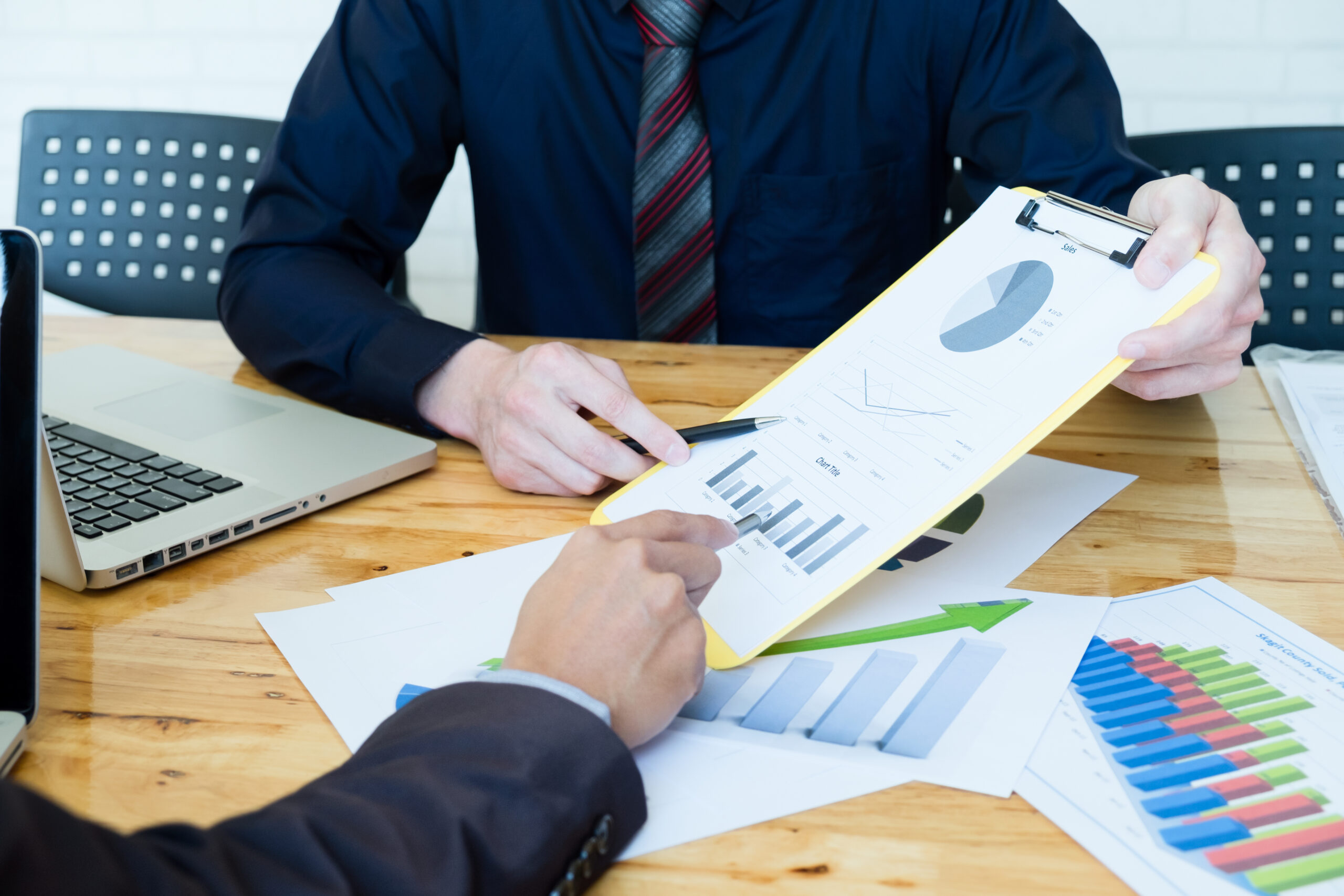 two men pontng at revocable living trust charts and paperwork