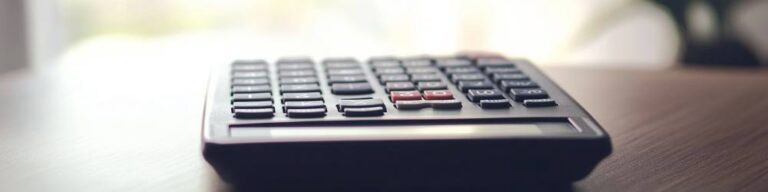 a calculator sitting on a wooden table