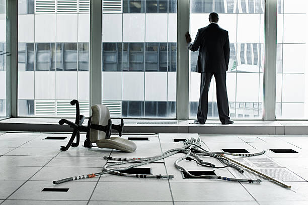 man standing thinking about business in a commercial building 