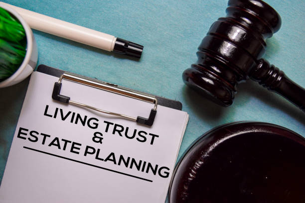 Living trust and Estate Planning text on Document form and Gavel isolated on office desk.