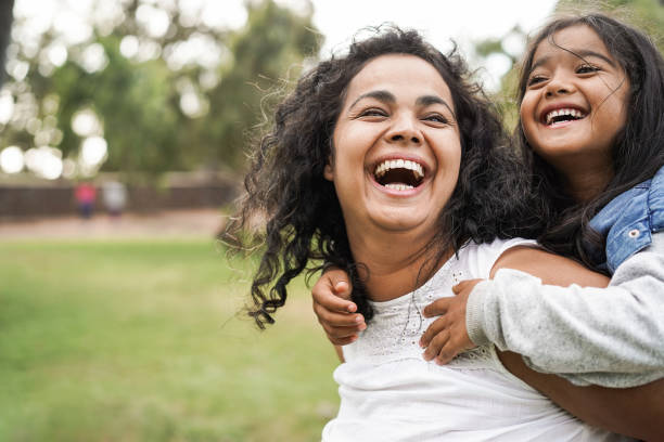 Happy indian mother having fun with her daughter outdoor - Family and love concept - Focus on mum face, Understanding Default Parent Responsibilities & Texas Custody Law