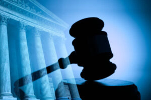 A gavel and the United States Supreme Court building.