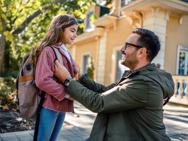 Daughter and father smiling at each other