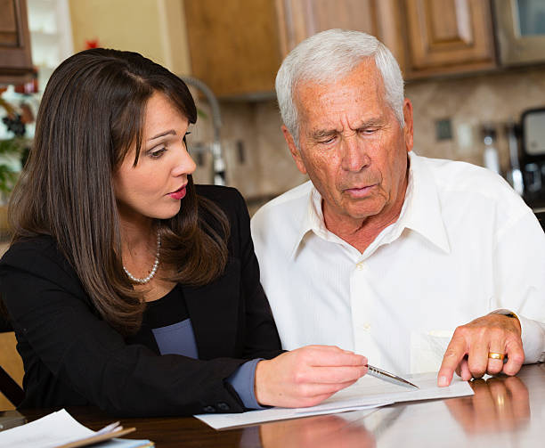 A business woman working with her senior citizen client.