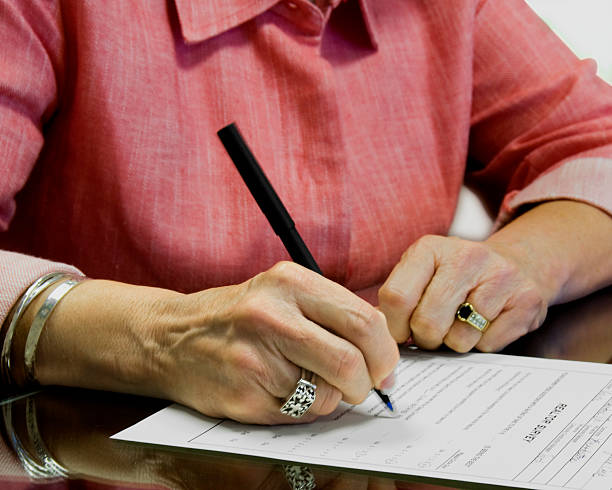 Senior Citizen Signing a will document