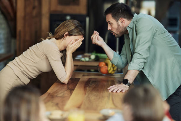 Frustrated parents having an argument in the kitchen.