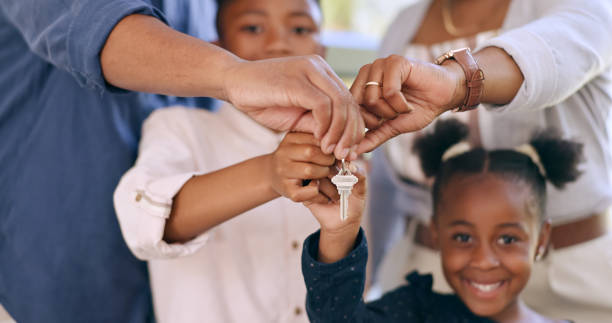 Family, children and hands for key in new house for real estate, property investment or mortgage loan in closeup. Happiness, homeowner and excited for new beginning with love, care or hope for future