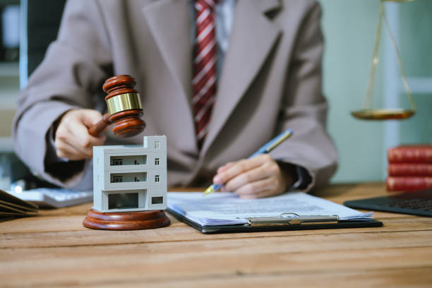 Justice and law concept. Real Estate Law in a courtroom the gavel, working with digital tablet computer on wood table.