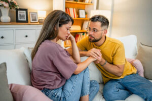 Caring husband holding his wife hand and showing empathy and support