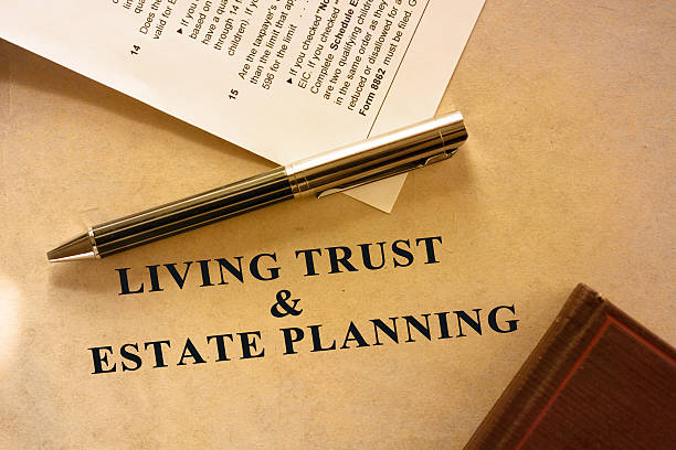 Sepia shaded image of living trust and estate planning document. A tax form is also included in the scene.