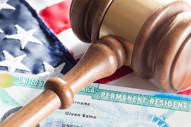 Immigration concept. United States Permanent Resident with gavel and identification card