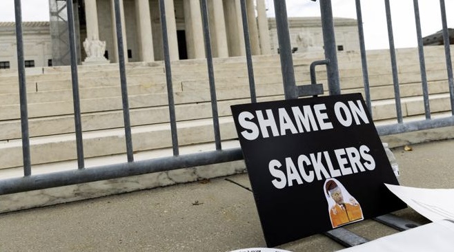 shame on sacklers sign outside of the supreme court in july 2024