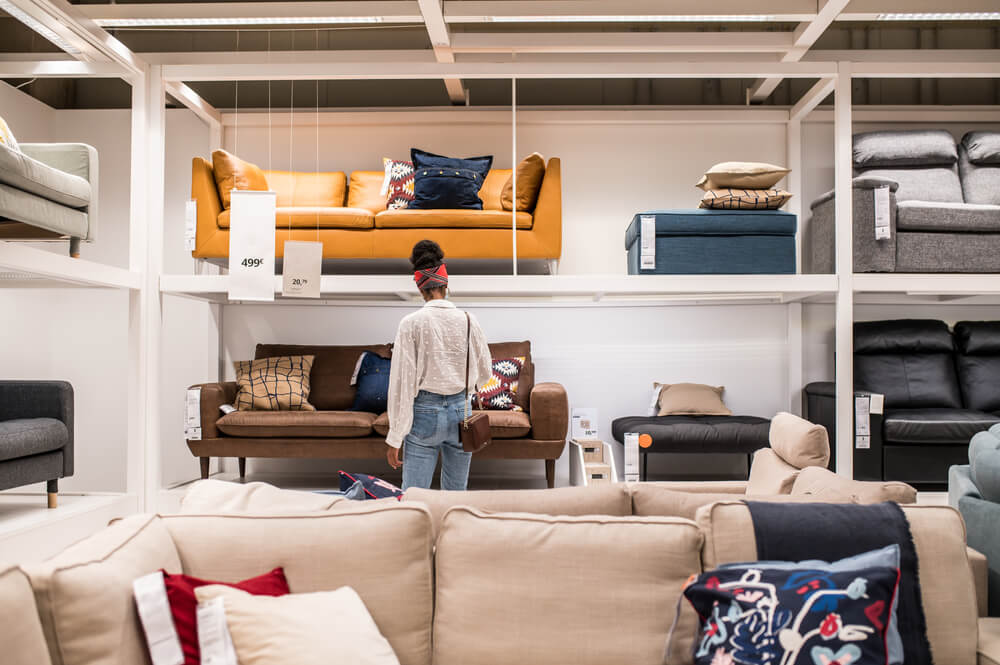 A woman in a furniture store looking for a couch 