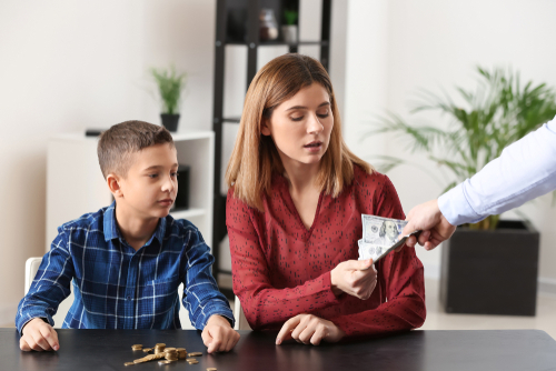 Man giving alimony to his ex-family in lawyer's office