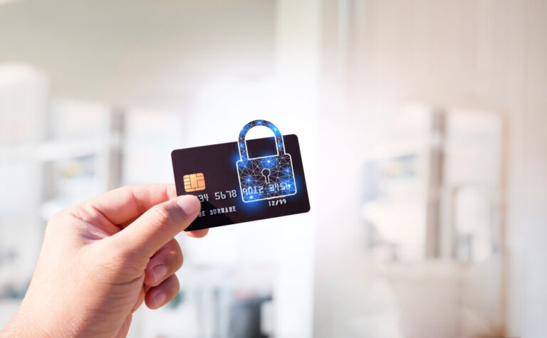 A woman holding a blue credit card up with a lock over the card showing it is secure