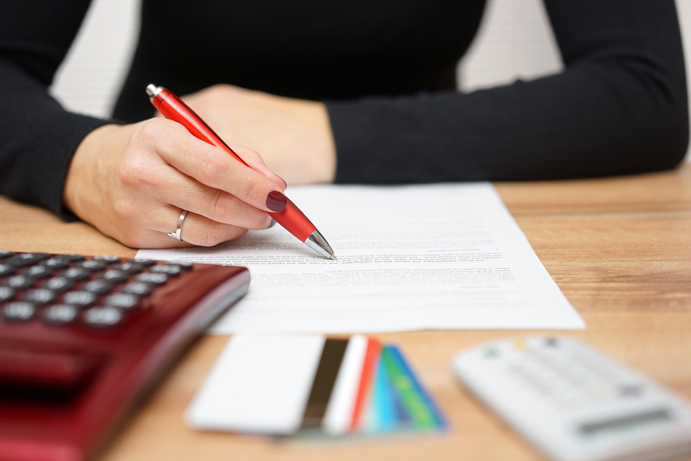 woman is reading bank notice about credit card spending and  repayment of debt