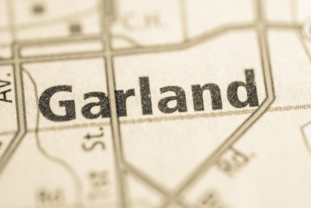 A close-up view of a vintage map shows the area labeled "Garland" with surrounding streets partially visible.