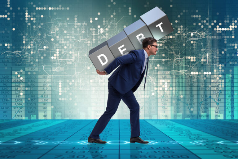 debt blocks carrying by man to showcase the burden of high debt on his shoulder