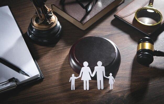 A conceptual image of a family cutout with a gavel and legal books, suggesting themes of family law.