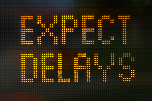 LED sign displaying the words "EXPECT DELAYS" in bright yellow text—