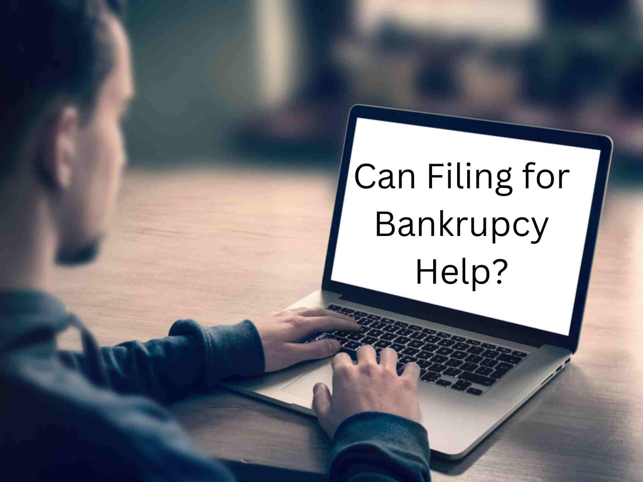 A person typing on a laptop with a screen displaying the text "Can Filing for Bankruptcy Help?.