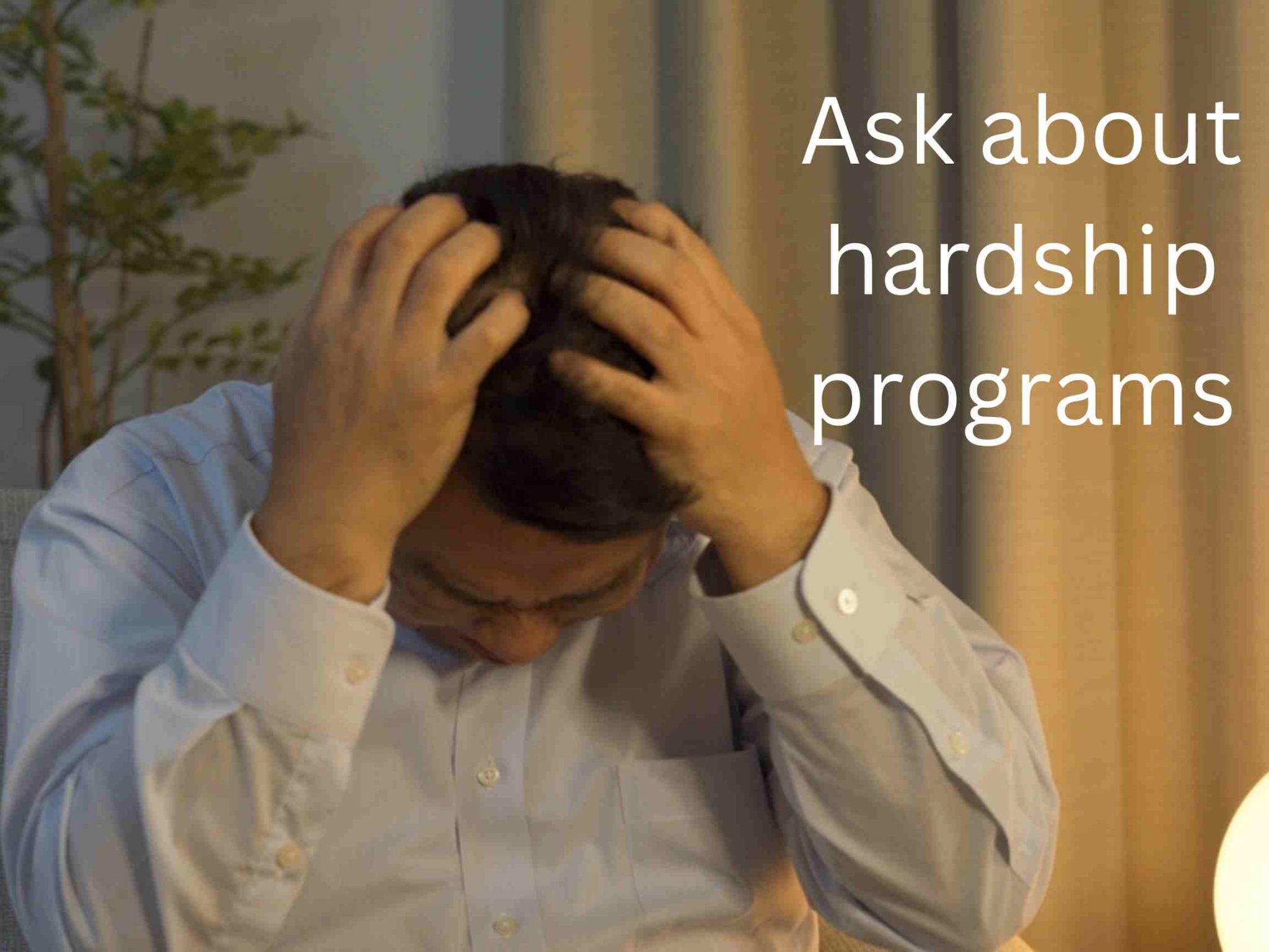 Person with head in hands, stressed, next to text: "Ask about hardship programs and learn how to get out of debt on a low income.