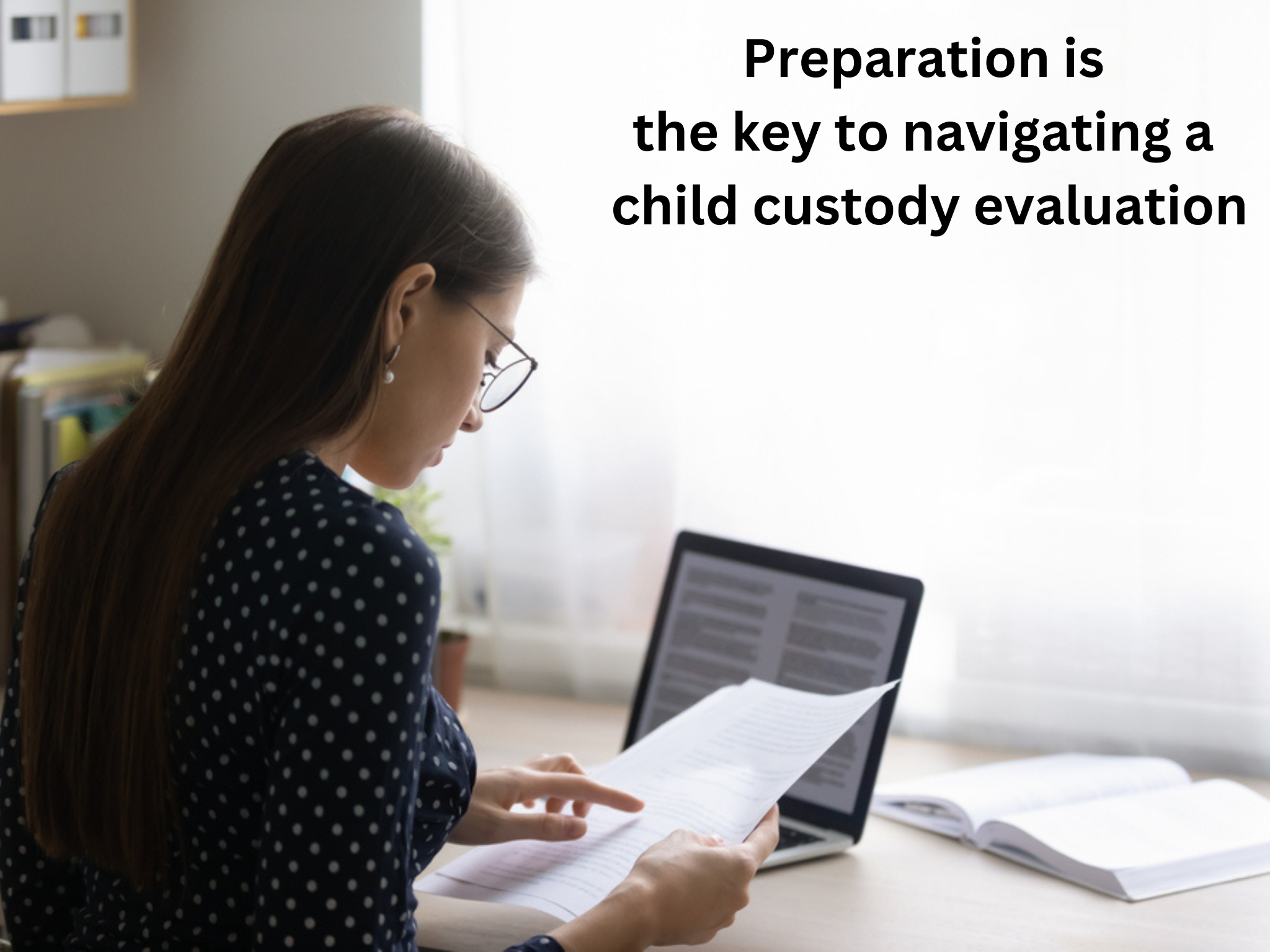 A woman, engrossed in reading documents at her desk surrounded by an open laptop and books, embodies the phrase "Preparation is the key to navigating a child custody evaluation." She's mastering how to prepare for a child custody evaluation with focused determination.